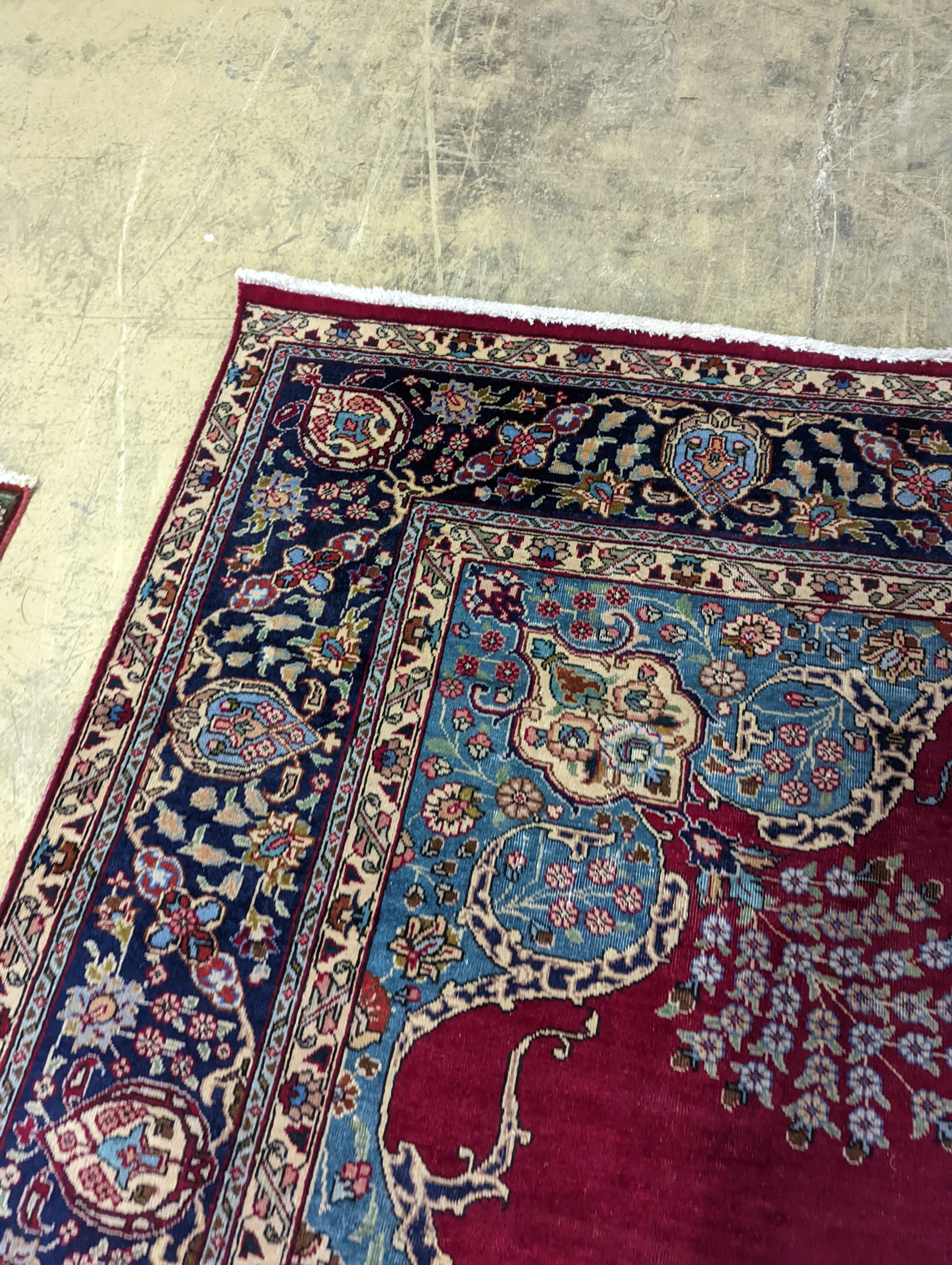 A Tabriz burgundy ground carpet, 350 x 240cm